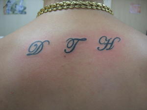 tatouage initiale haut du dos